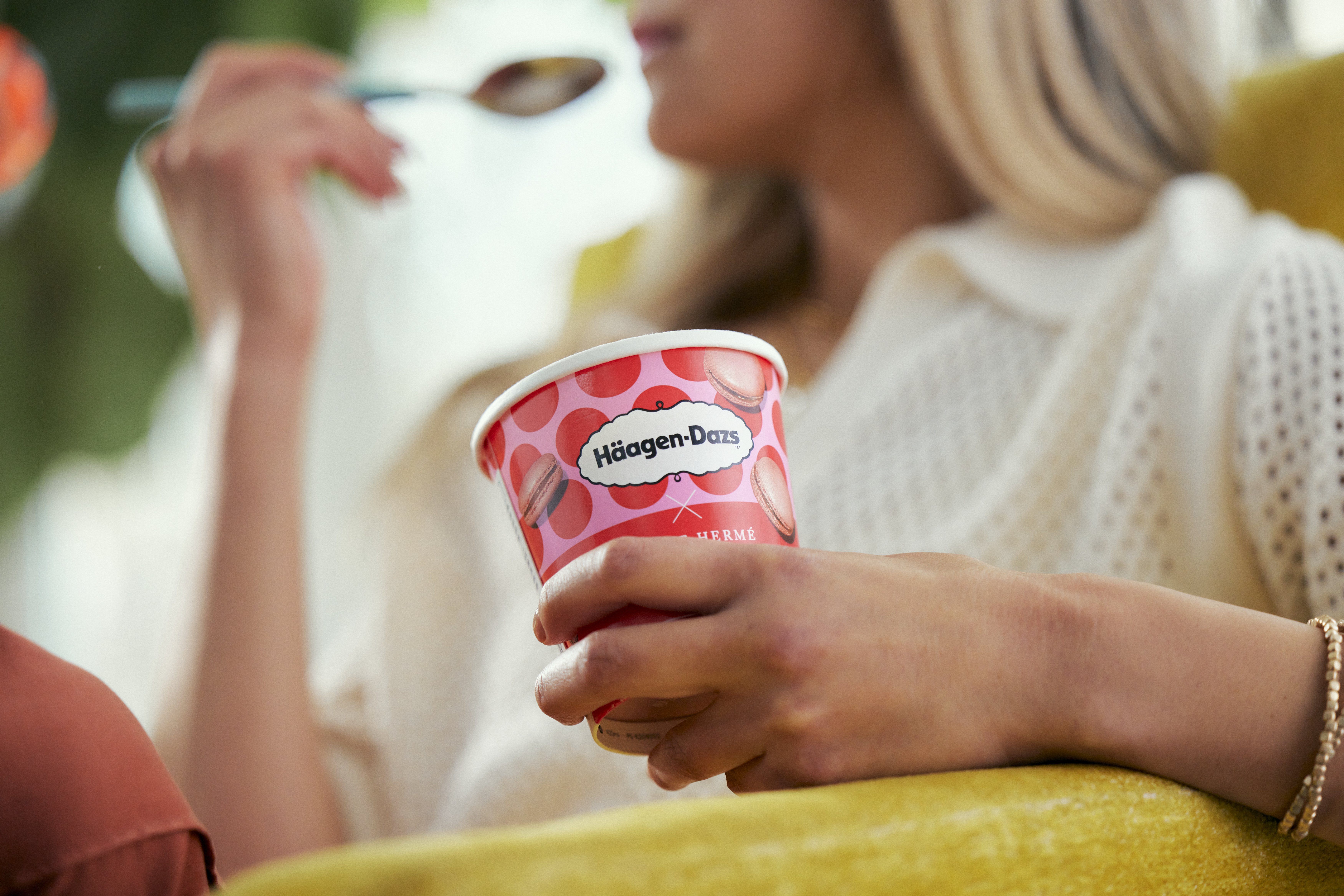 Woman eating pint of Haagen-Dazs ice cream